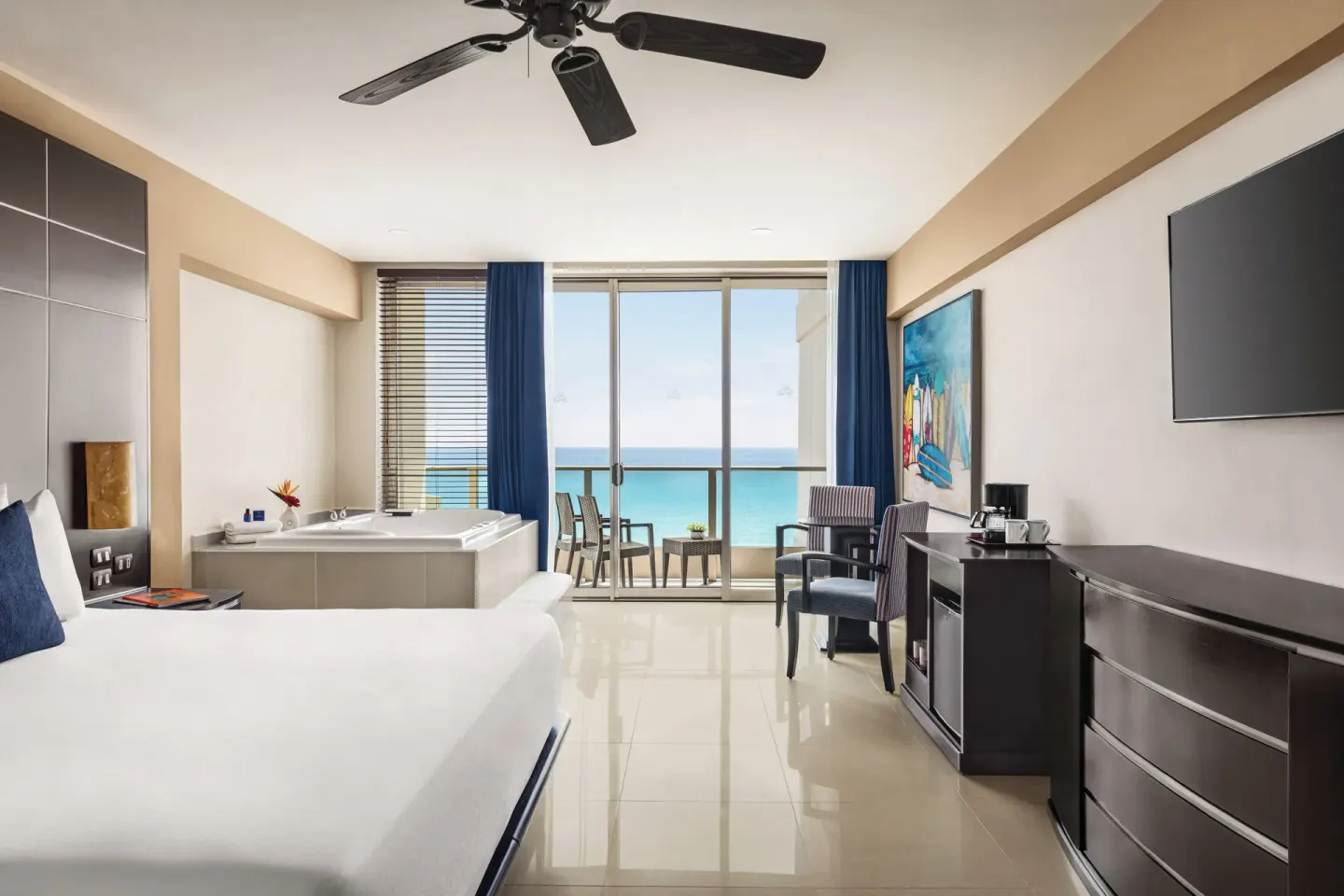 Premium Suite with king bed, soaking tub, balcony, and ocean view at Seadust Cancún Family Resort.