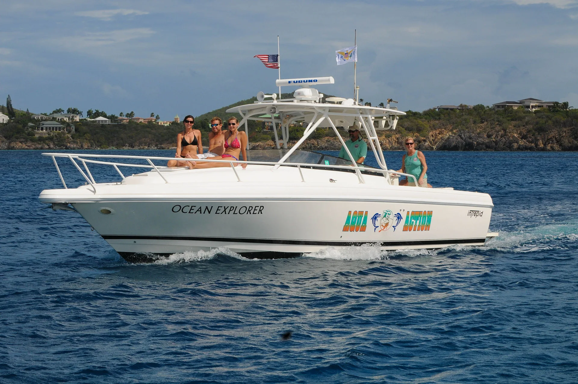 Guests ride a white excursion boat offshore from Secret Harbour Beach Resort.