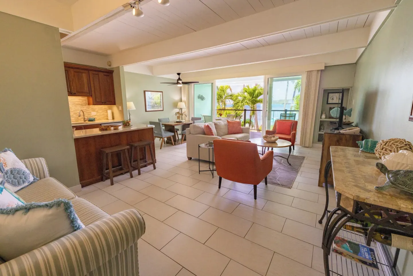 Open living area with kitchen, seating, and balcony at Secret Harbour Beach Resort.