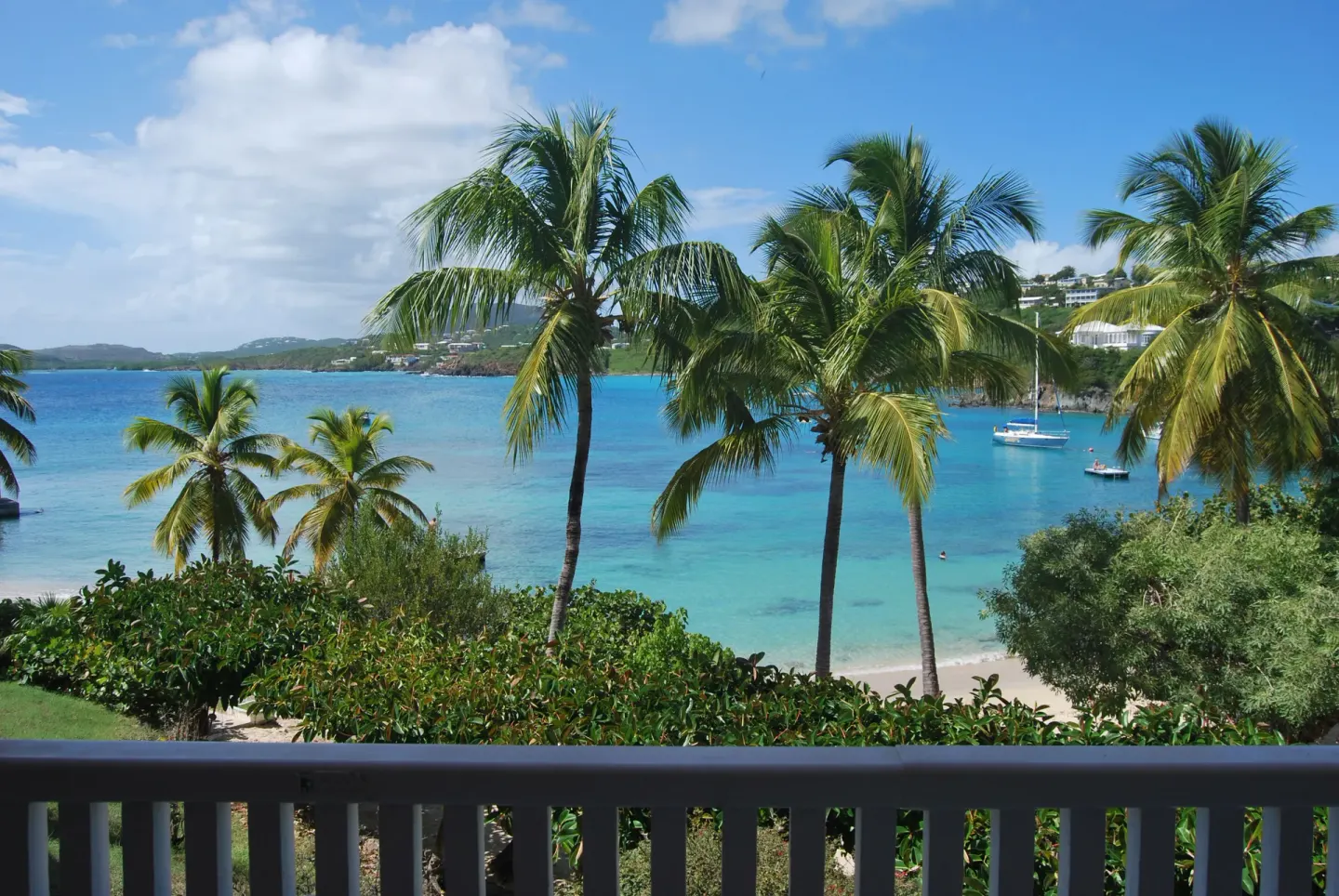 Palm trees frame the turquoise bay and beach at Secret Harbour Beach Resort.
