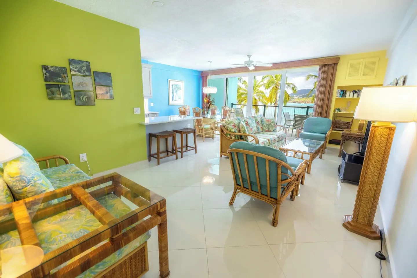 Spacious suite living and dining room at Secret Harbour Beach Resort with balcony views.