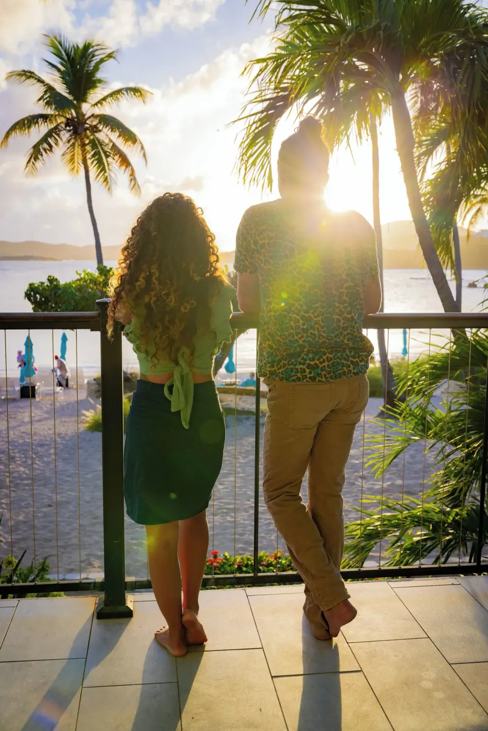 Couple watching the sunset from a balcony at Secret Harbour Beach Resort.