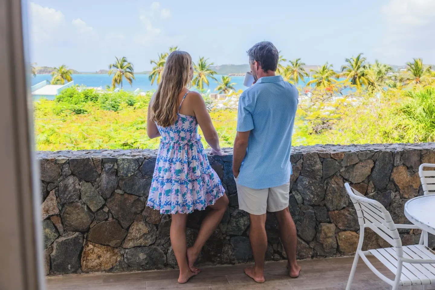 Couple viewing palms and ocean from a terrace at Secret Harbour Beach Resort.