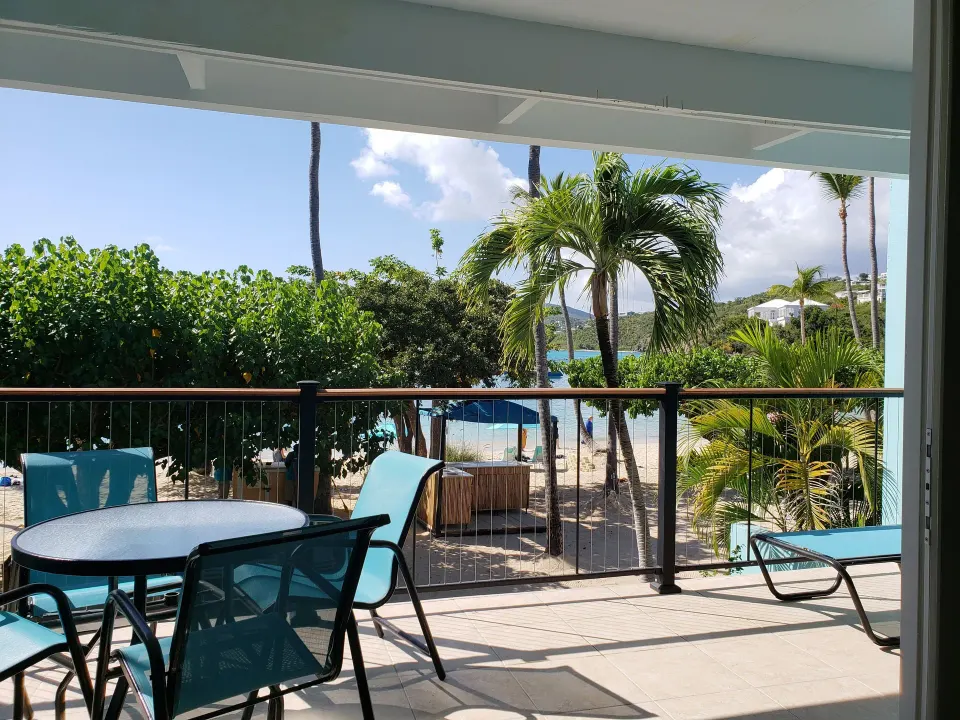 Beachfront condo balcony with seating and beach view at Secret Harbour Beach Resort.
