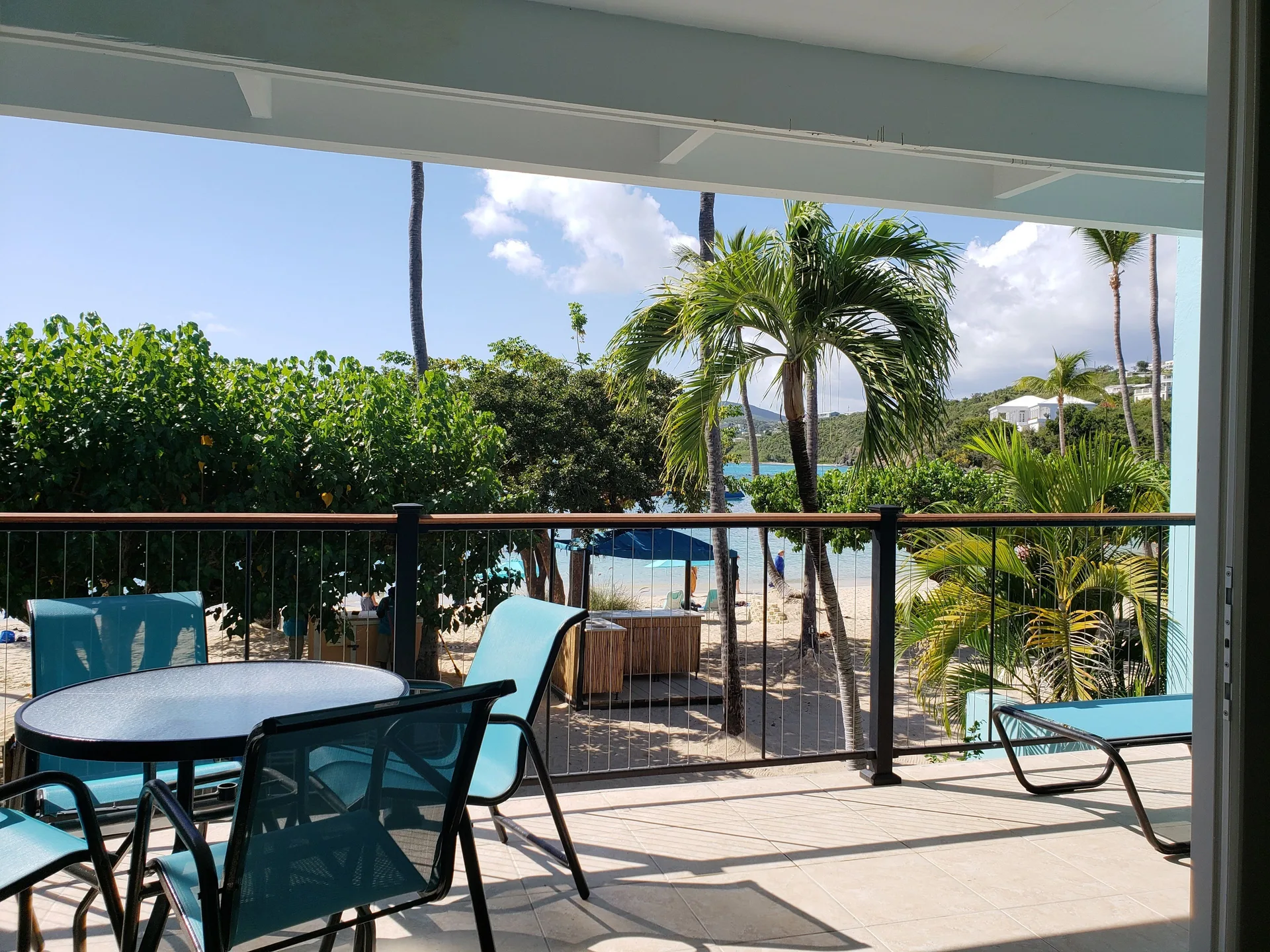 Beachfront condo balcony with seating and beach view at Secret Harbour Beach Resort.