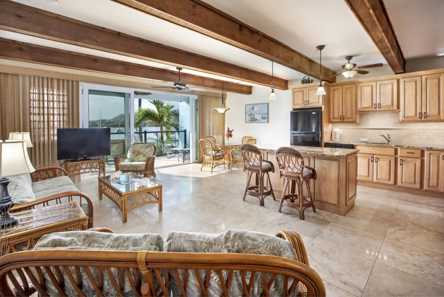 Beachfront one-bedroom condo living room and kitchen at Secret Harbour Beach Resort.