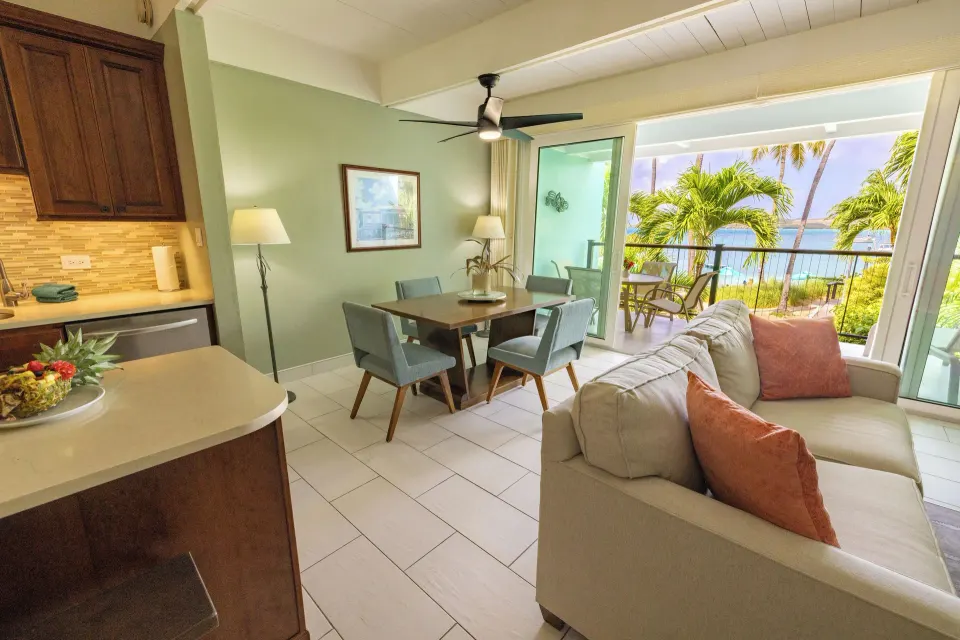 Beachfront condo living and dining area with patio view at Secret Harbour Beach Resort.