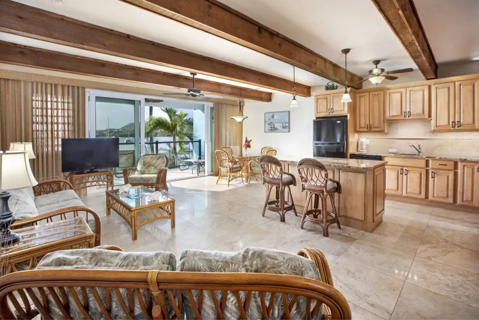 Beachfront one-bedroom condo living room and kitchen at Secret Harbour Beach Resort.