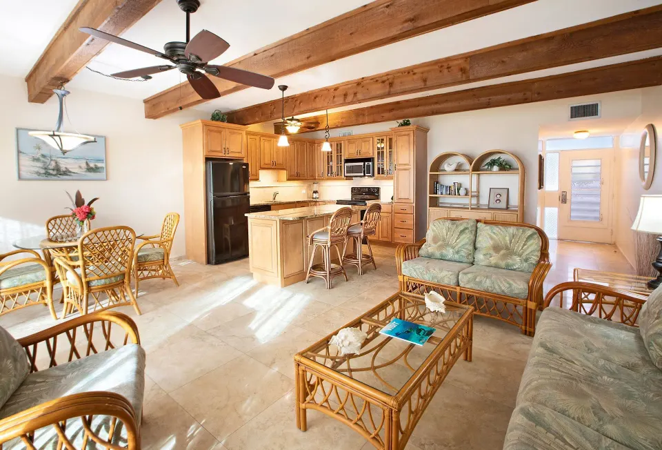 Beachfront one-bedroom condo lounge and kitchen at Secret Harbour Beach Resort.