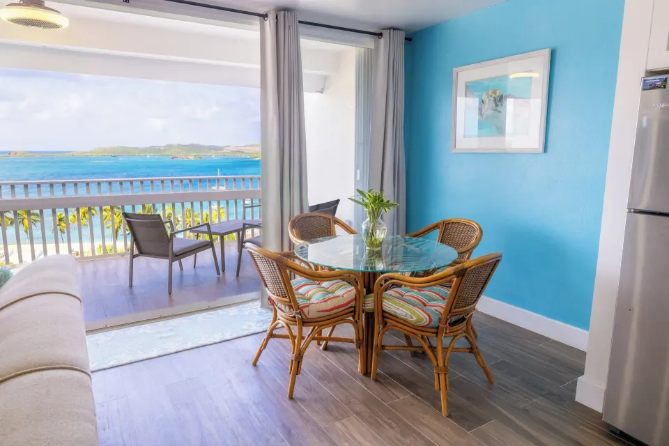 Dining table and balcony view in a one bedroom condo at Secret Harbour Beach Resort.