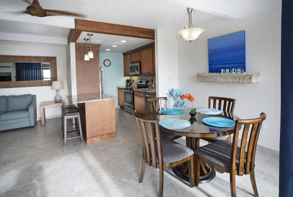 Dining area and kitchen in a hillside one bedroom condo at Secret Harbour Beach Resort.