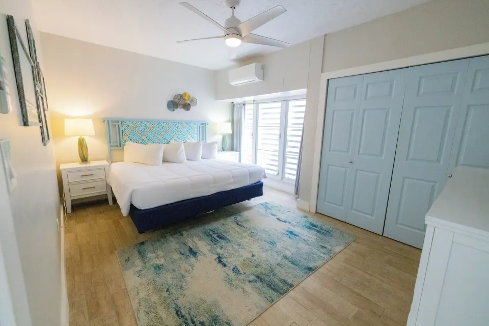 Bedroom with king bed in a hillside one bedroom condo at Secret Harbour Beach Resort.