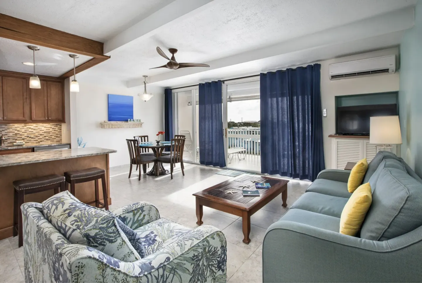 Living room with balcony access in a hillside one bedroom condo at Secret Harbour Beach Resort.