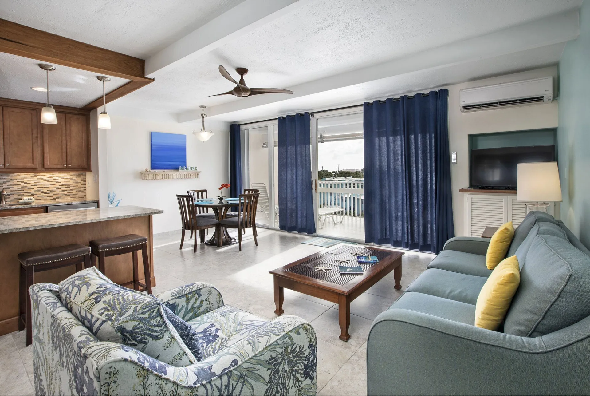 Living room with balcony access in a hillside one bedroom condo at Secret Harbour Beach Resort.