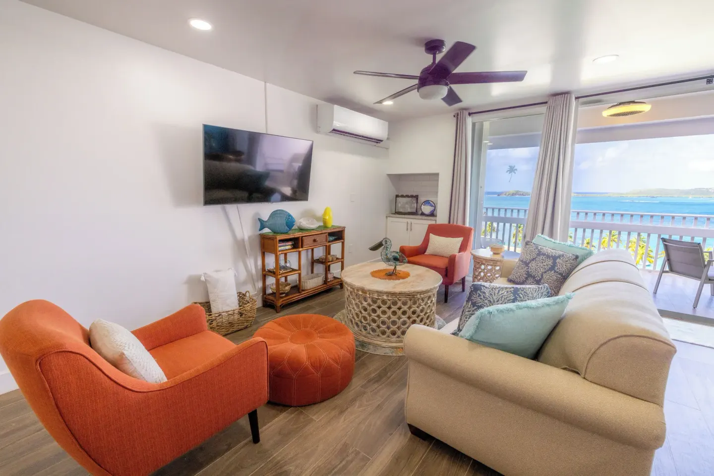 Living room with balcony and sea view in a condo at Secret Harbour Beach Resort.