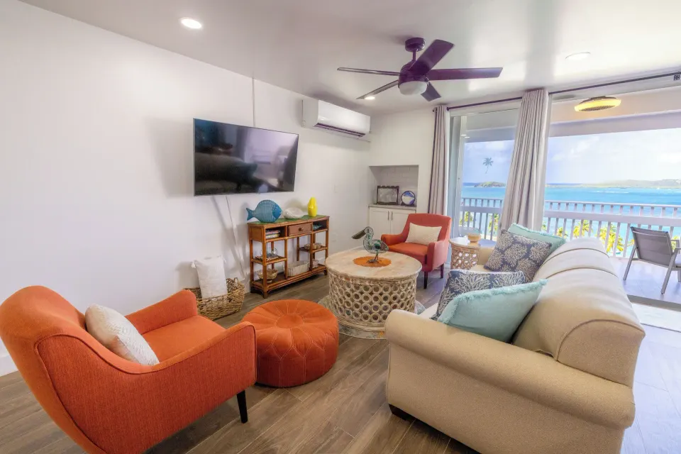 Living room with balcony and sea view in a condo at Secret Harbour Beach Resort.