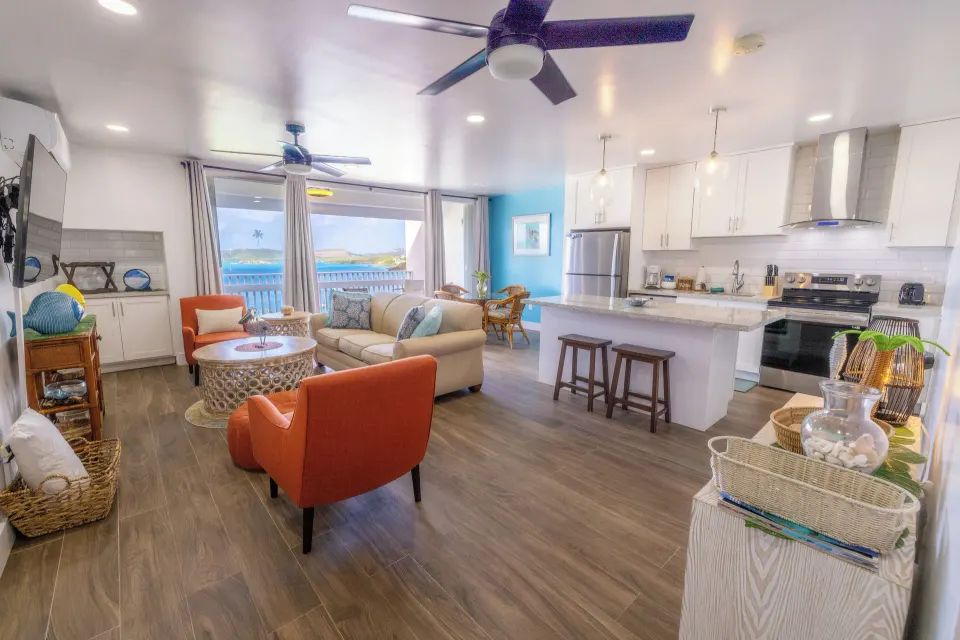 One-bedroom hillside condo living room and kitchen at Secret Harbour Beach Resort.
