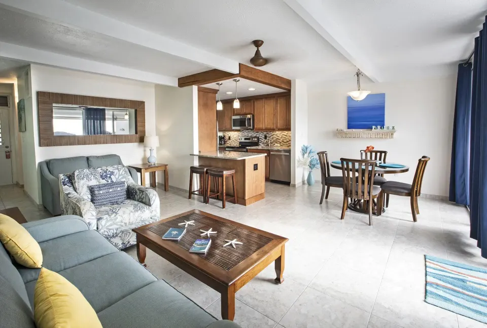 Open living, dining, and kitchen area in a hillside condo at Secret Harbour Beach Resort.