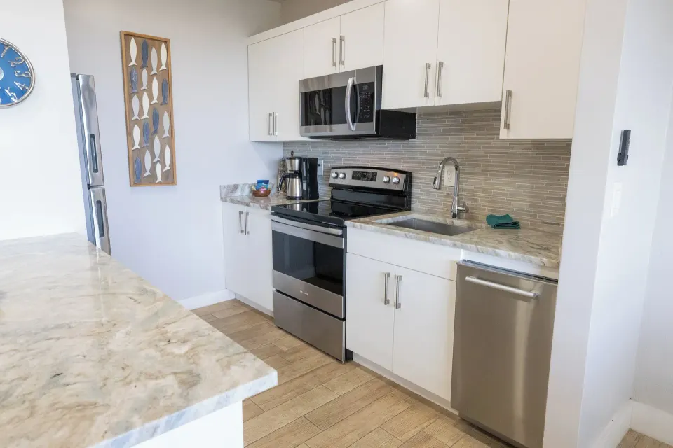 Hillside two-bedroom condo kitchen with stainless appliances at Secret Harbour Beach Resort.