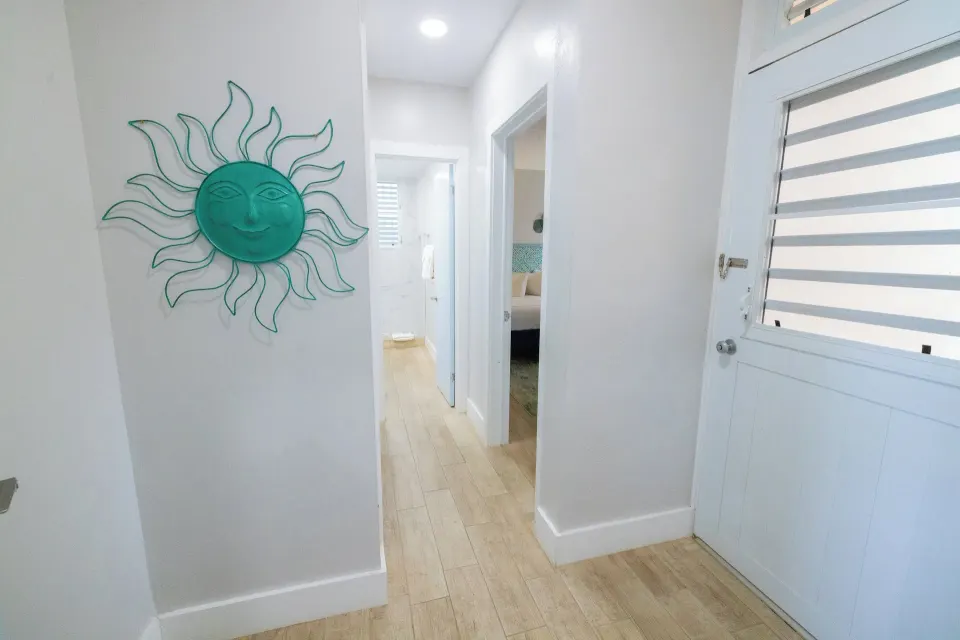 Entry hallway with sun wall decor in a hillside condo at Secret Harbour Beach Resort.