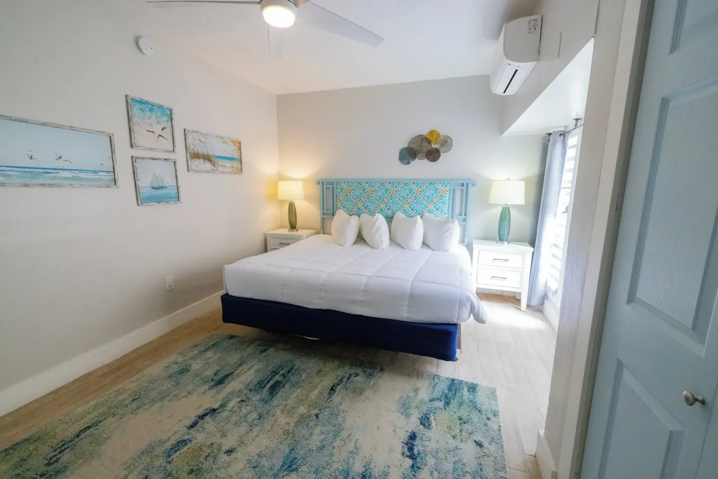 King bedroom with turquoise headboard in a hillside condo at Secret Harbour Beach Resort.