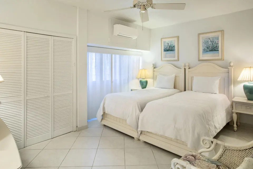 Twin beds in a hillside two-bedroom condo at Secret Harbour Beach Resort.
