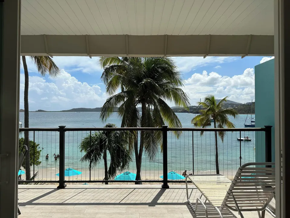 Beachfront Studio Suite balcony view over beach and bay at Secret Harbour Beach Resort.