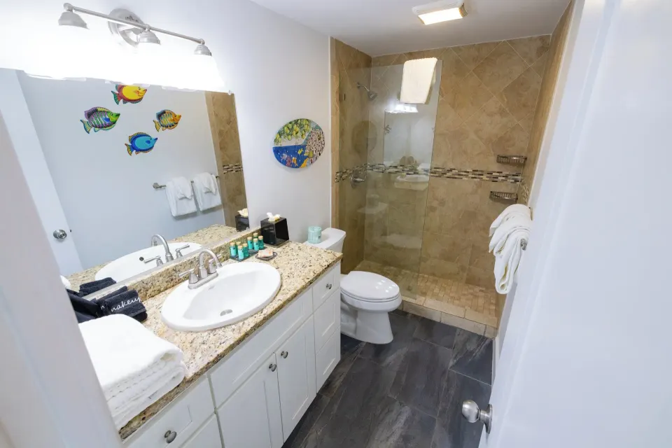 Beachfront Studio Suite bathroom vanity and shower at Secret Harbour Beach Resort.