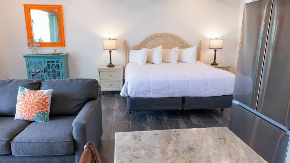 Beachfront Studio Suite bed and sitting area at Secret Harbour Beach Resort.