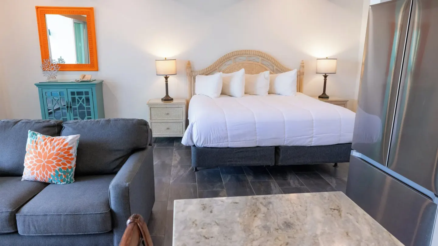 Beachfront Studio Suite king bed and sofa at Secret Harbour Beach Resort.