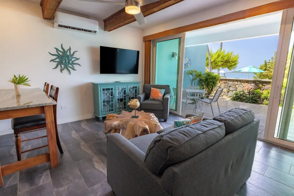 Beachfront Studio Suite living area opening to patio at Secret Harbour Beach Resort.