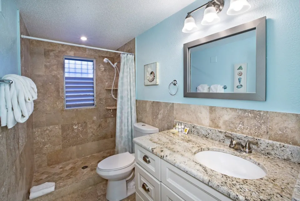 Studio Suite hillside bathroom with walk-in shower at Secret Harbour Beach Resort.