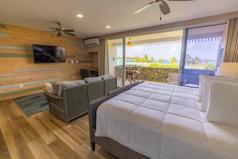 Studio Suite with bed, sitting area and balcony view at Secret Harbour Beach Resort.