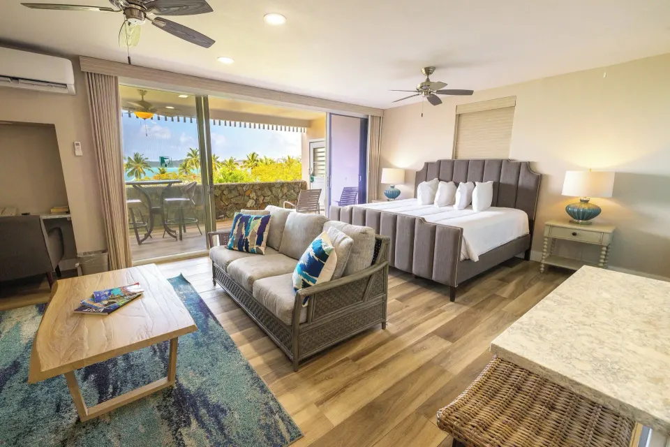 Studio Suite with king bed, sofa and balcony at Secret Harbour Beach Resort.