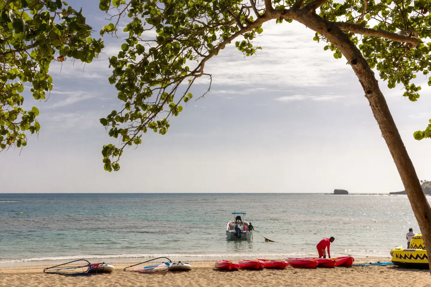 Beach with water sports equipment and a small boat at Senator Puerto Plata.