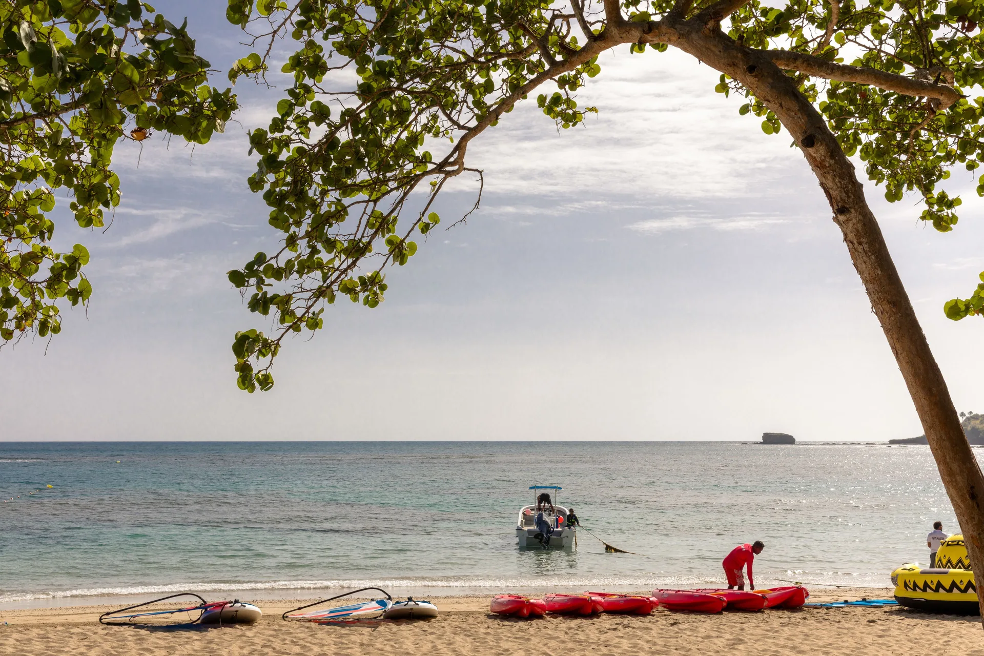 Beach with water sports equipment and a small boat at Senator Puerto Plata.