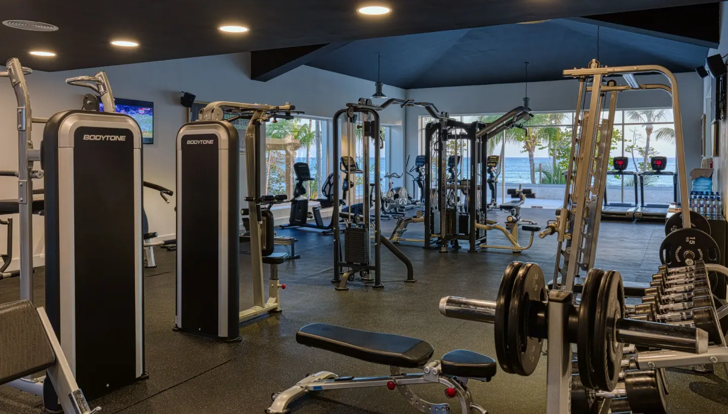 Fitness center with weight machines and ocean-facing windows at Senator Puerto Plata.