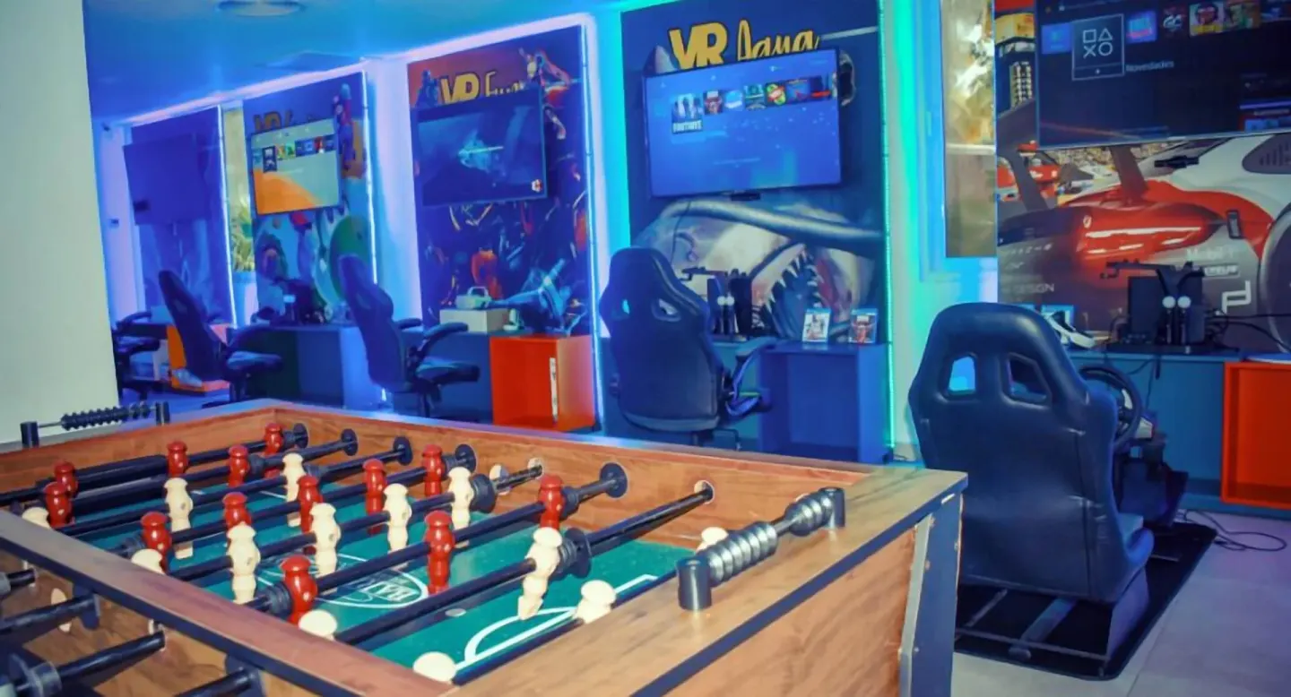 Game room with foosball table and racing stations at Senator Puerto Plata.