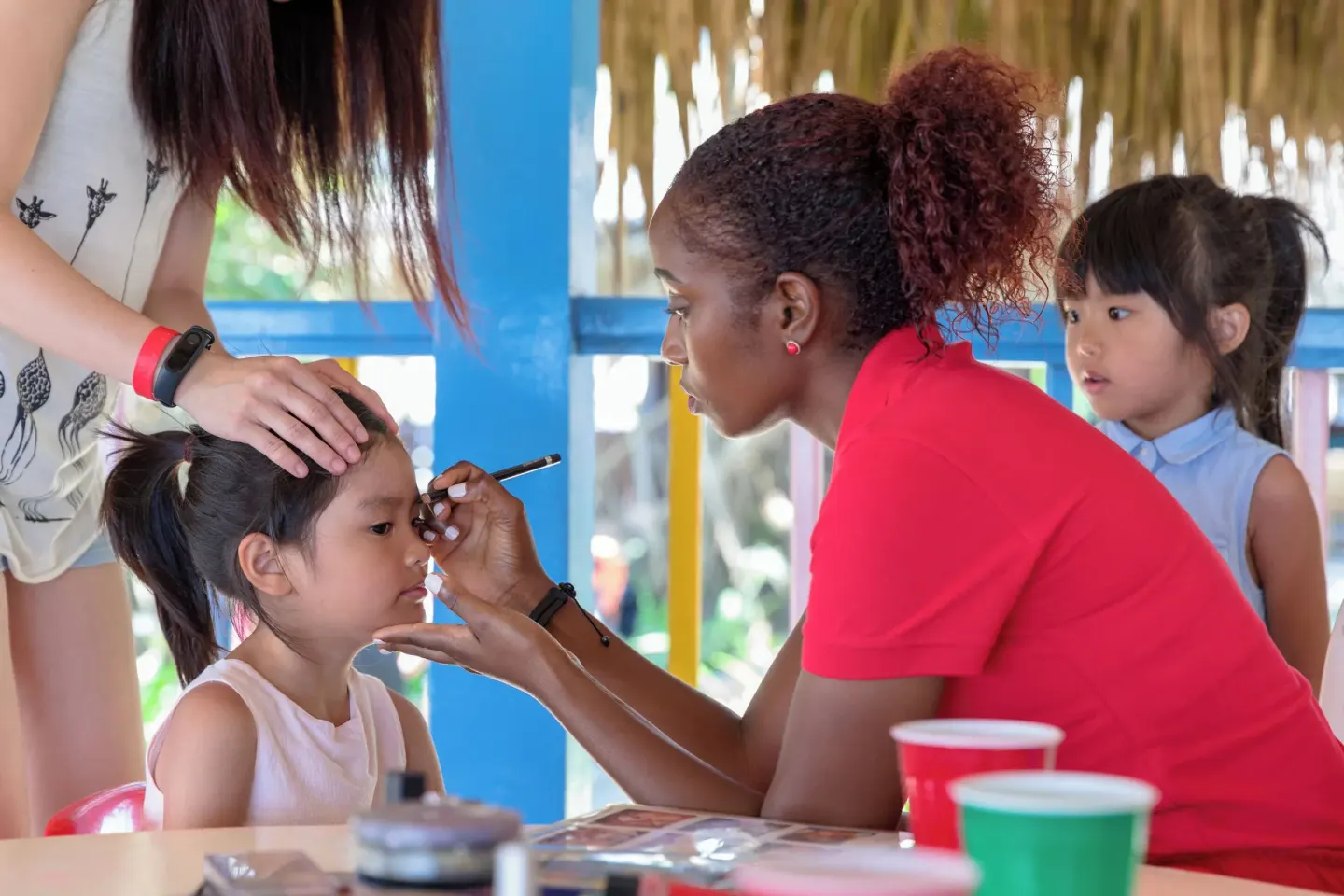 A child has face paint applied during a kids activity at Senator Puerto Plata.