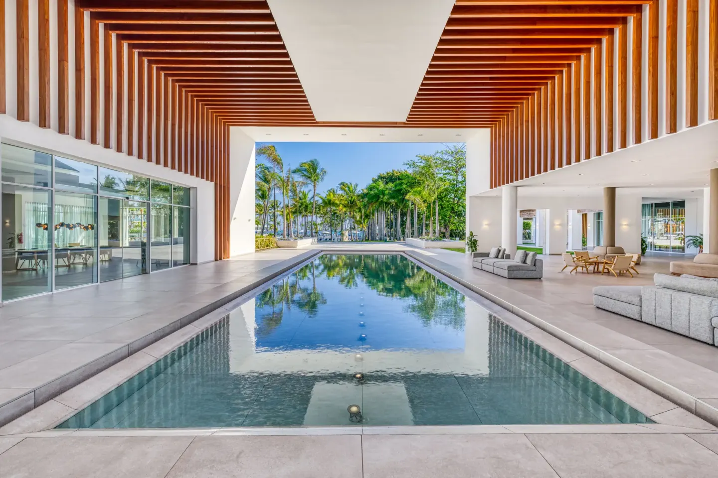 Reflecting pool and open lobby pavilion with palm views at Senator Puerto Plata.