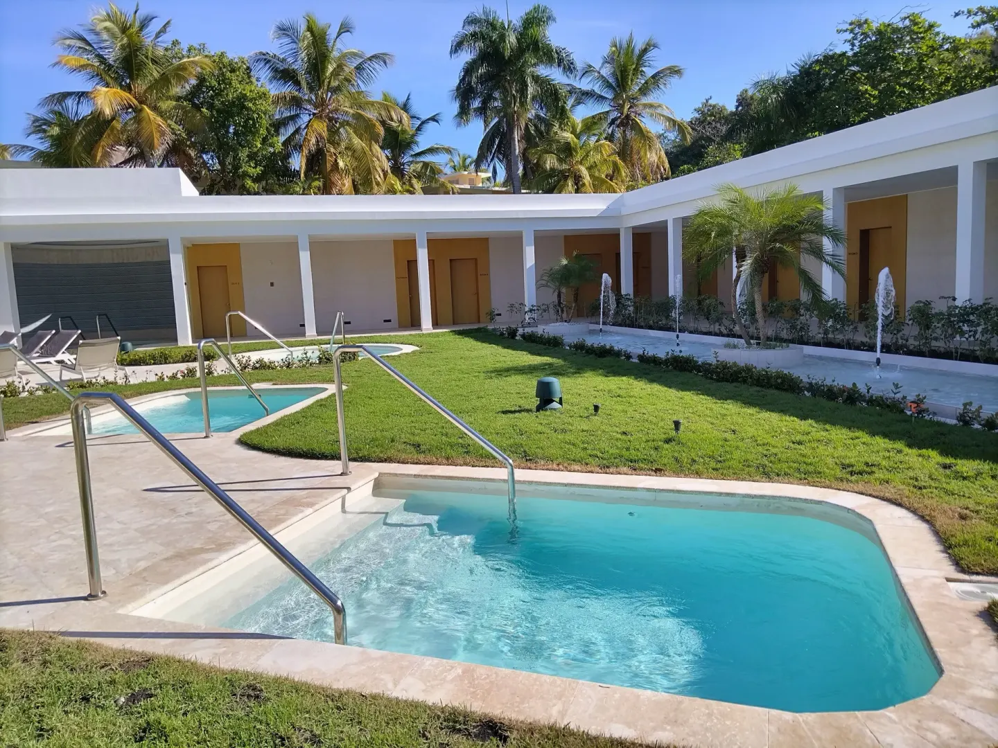 Small spa pools, fountains, and garden paths at Senator Puerto Plata.