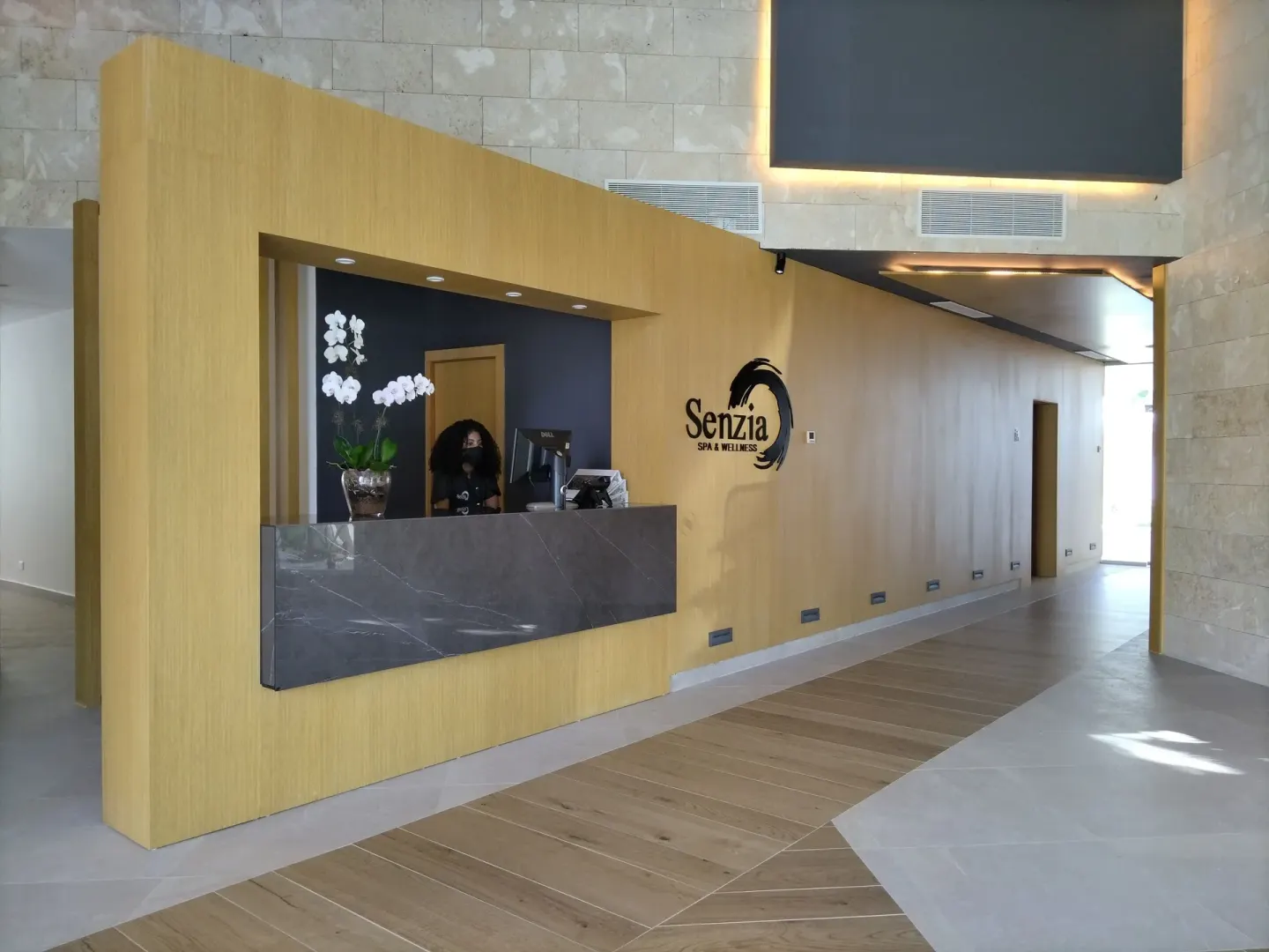 Spa reception desk with wall signage at Senator Puerto Plata.