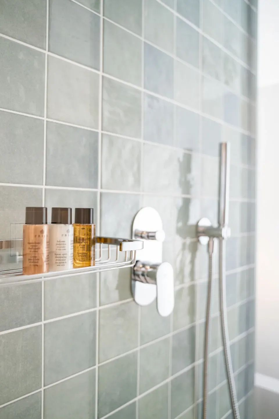 Shower wall with tiled surround and bath amenities at Senator Puerto Plata.