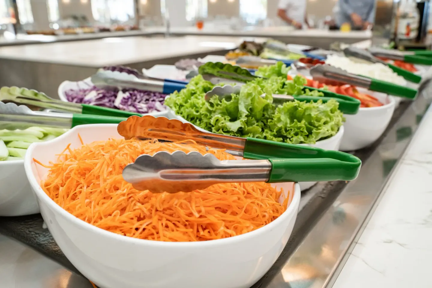 Fresh salad ingredients in white bowls on the buffet at Senator Puerto Plata.