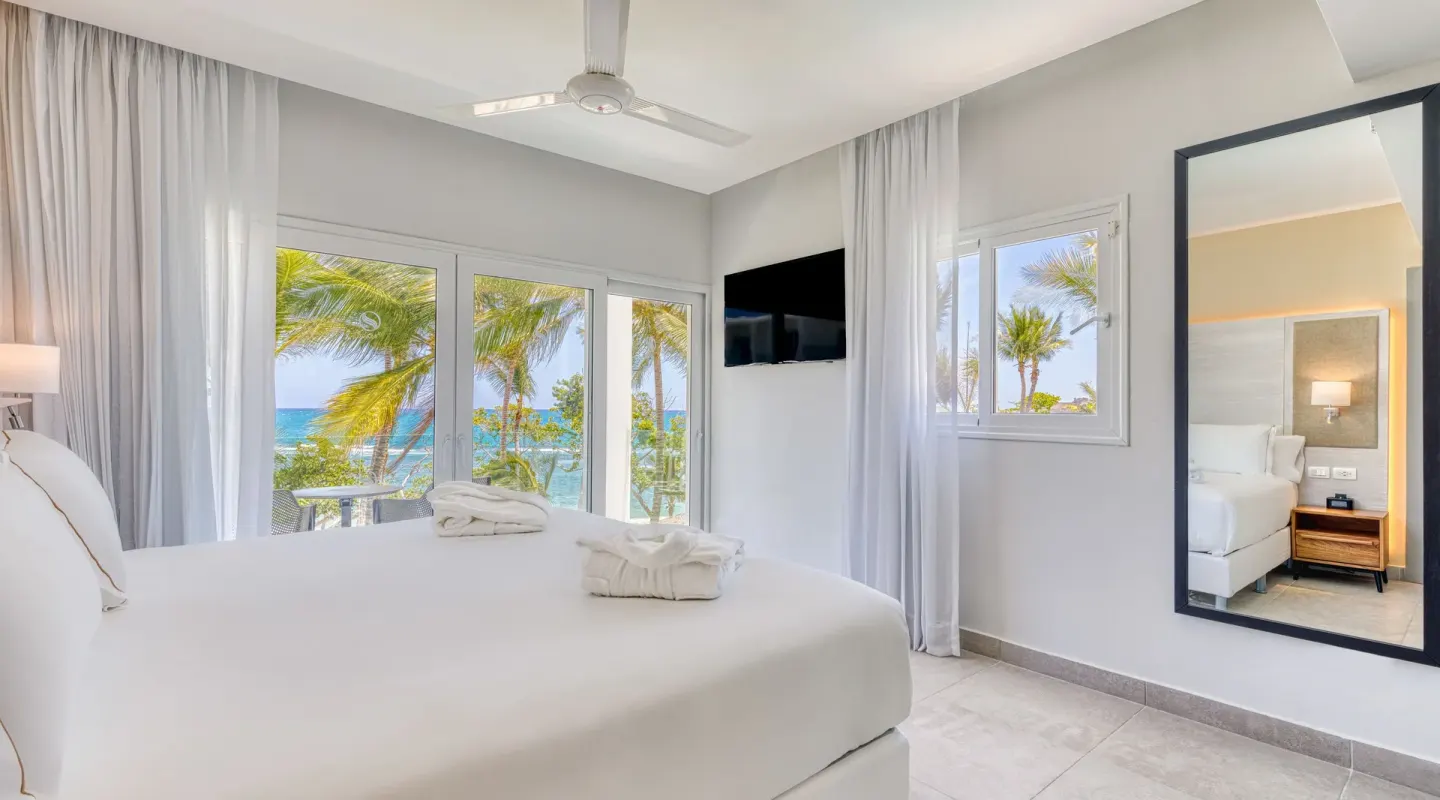 Imperial One Bedroom Suite king bed with ocean-facing windows at Senator Puerto Plata.
