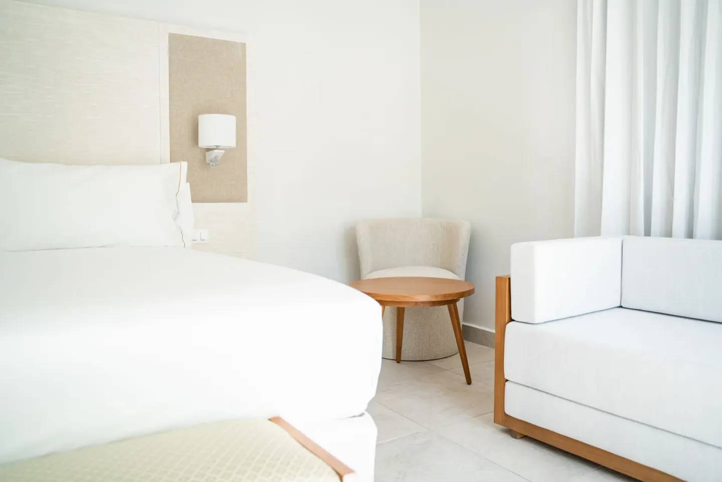Imperial One Bedroom Suite seating area and bed at Senator Puerto Plata.