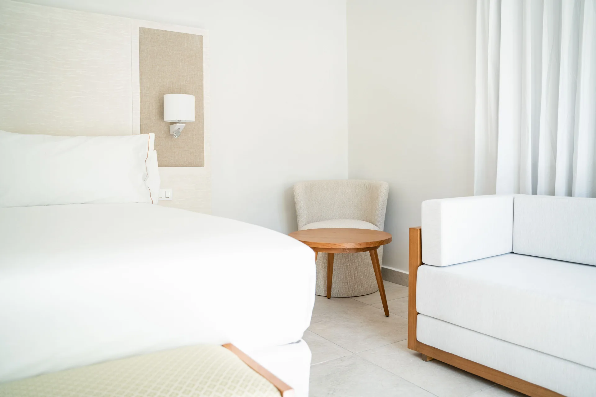 Imperial One Bedroom Suite seating area and bed at Senator Puerto Plata.