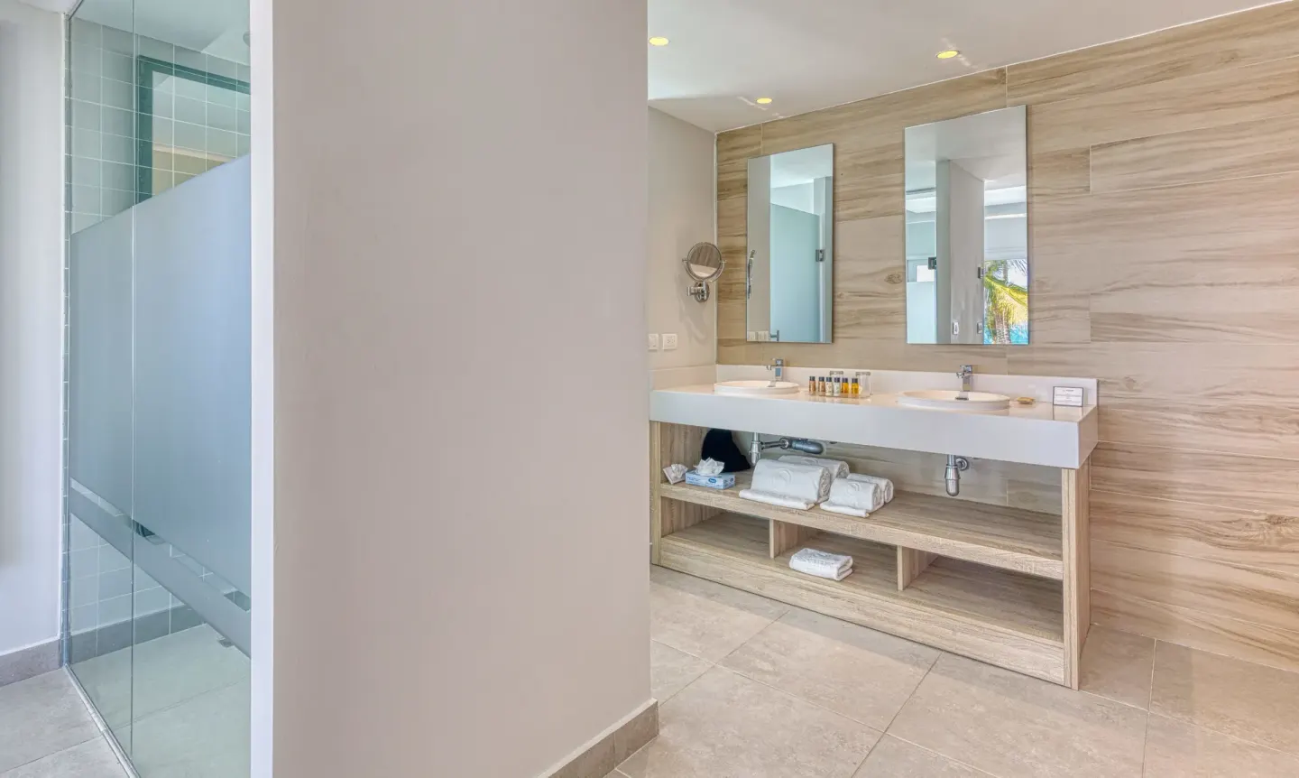 Imperial Suite bathroom with double vanity and glass shower at Senator Puerto Plata.