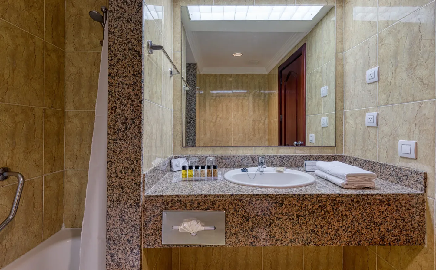 Senator Puerto Plata junior suite bathroom with vanity, mirror, tub, towels, and amenities.