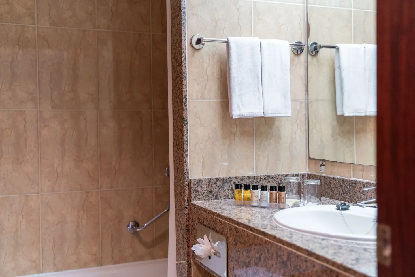 Senator Puerto Plata bathroom at Senator Puerto Plata with sink, mirror, towels, amenities, and tub.